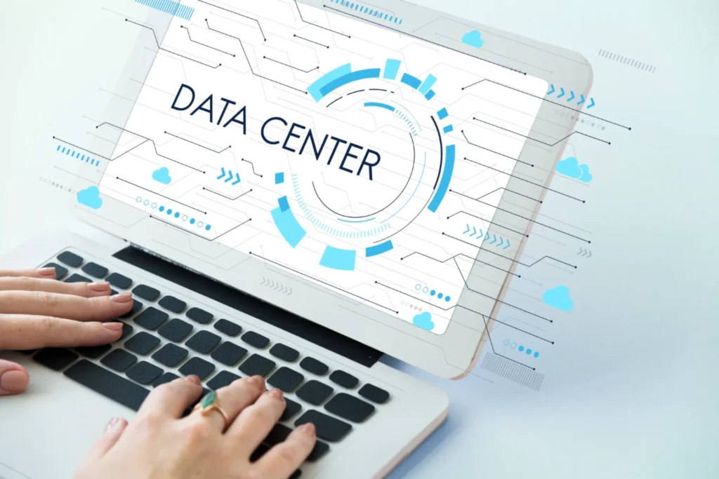 Person typing on laptop, data center graphic displayed.