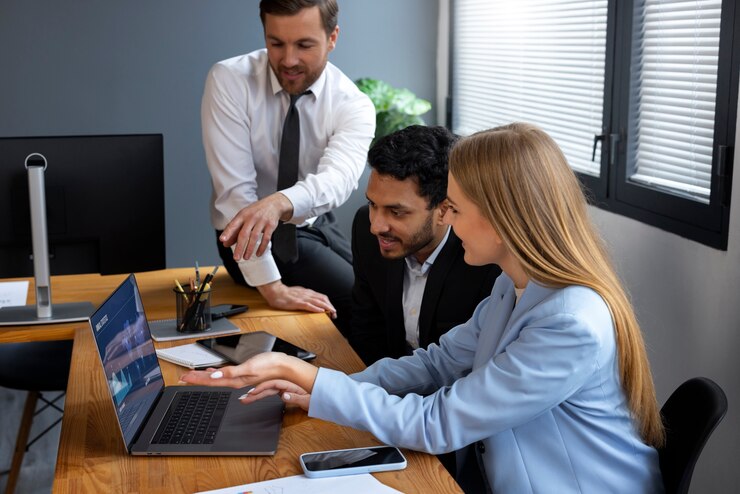 Business team collaborating on a laptop.